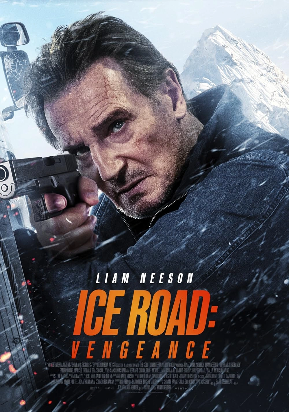 Liam Neeson aiming a gun intensely, with snow and ice shards flying around him; a rugged snowy mountain is in the background. The text reads Liam Neeson Ice Road: Vengeance.